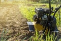 A close up view on motor cultivator during spring season garden works