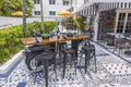 Close-up view at motorcycle-shaped table in street-side tavern, capturing unique outdoor ambiance.