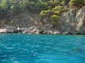 Amazing views from a pleasure yacht on the rocky coast of the Lycian Trail washed by the azure sea.