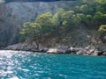 Amazing views from a pleasure yacht on the rocky coast of the Lycian Trail washed by the azure sea.