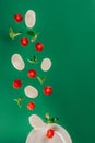 close up view of mozzarella cheese cherry tomatoes spinach falling on plate Royalty Free Stock Photo