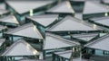 Close-up view of multiple clear glass prisms with triangular shapes, arranged closely together. Royalty Free Stock Photo