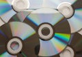Collection of shiny compact discs reflecting rainbow colors scattered across surface isolated on white background Royalty Free Stock Photo