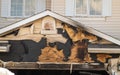 A close-up view of a neighborhood garage roof, which bears the scars of recent accidental fire damage