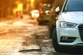 Close-up view of a new modern car parked on the side of the street. Soft ligtht effect. Royalty Free Stock Photo