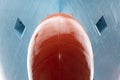 Close up view on the newly red painted bulbous bow of the big container ship.