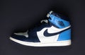 Close-up view of a Nike Air Jordan 1 Off White UNC over the black background