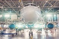 Close up view nose aircraft inside the aviation hangar, maintenance service