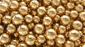 Close-up view of numerous reflective golden spheres packed tightly