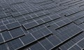 close-up view numerous solar panels arranged in grid-like pattern, with dark blue color and slightly blurred Royalty Free Stock Photo
