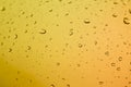 Close up view of numerous water droplets on a yellow surface with a gradient effect offering a beautiful texture Royalty Free Stock Photo