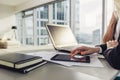 Close-up view of office desk: laptop, notebooks, papers, tablet computer at modern penthouse Royalty Free Stock Photo