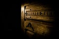 Close up view of old antique wooden door inside dark room. Selective focus Royalty Free Stock Photo