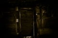 Close up view of old antique wooden door inside a dark room. Selective focus Royalty Free Stock Photo