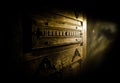 Close up view of old antique wooden door inside dark room. Selective focus Royalty Free Stock Photo