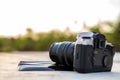 A close-up view of an old black camera and a sheet of film