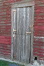 Close up view of old Dutch door on a weathered red 19th Century wooden barn Royalty Free Stock Photo