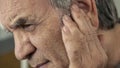 Close up view old man with earache Royalty Free Stock Photo