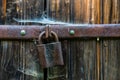 Close up view of the old rusty padlock on a aged gray wooden door Royalty Free Stock Photo