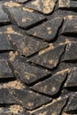 Close-up view of old used rubber mud terrain tire with worn wear-resistant tread
