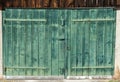 Close up view of an old vintage rustic green wooden barn door on a wooden shed Royalty Free Stock Photo