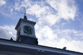 Close up view of old watch, compass and wind sign on the house roof.