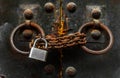 Old wooden door locked with rusty chain and padlock Royalty Free Stock Photo