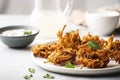 A plate of crispy onion bhajis, made with chickpea flour and a blend of fragrant spices. (Generative AI)