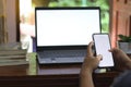 Close-up view of open blank screen laptop computer with office supplies on wood table Royalty Free Stock Photo