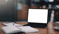 Close-up view of open blank screen laptop computer with office supplies in modern office Royalty Free Stock Photo