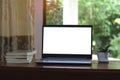 Close-up view of open blank screen laptop computer with office supplies on wood table Royalty Free Stock Photo