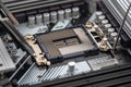 Close-up View of an Open CPU Socket on a High-tech Motherboard with Detailed Circuitry and Metallic Accents