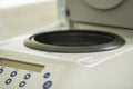 Close up view of an opened centrifuge and a part of the control pannel with an LCD screen and buttons. Royalty Free Stock Photo