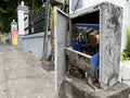 Broken electrical panel box in front of a building Royalty Free Stock Photo