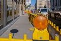 Orange amber caution light and plastic barriers to warn for construction site.