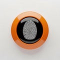 A close-up view of an orange fingerprint scanner button with a visible fingerprint Royalty Free Stock Photo