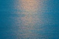 A orange sun way of reflections in blue water as background Royalty Free Stock Photo