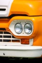 Close up view of orange and white vintage mini van head lamp