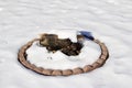 Close up view of an outdoor fire pit with logs, covered in white snow in winter Royalty Free Stock Photo