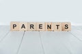 close up view of parents word made of wooden cubes on white