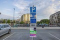 Close up view of parking sign for charging electric vehicles in parking lot near mall.