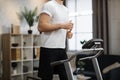 Close up view of part of body of young sportsman running on treadmill Royalty Free Stock Photo