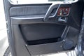 A close-up view of a part of the interior of a old classic car with a view of a black door with brown wood and leather trim after Royalty Free Stock Photo