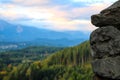 Close-up view of a part of a stone wall. Mountains and green forest