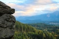 Close-up view of a part of a stone wall. Mountains and green forest out of focus