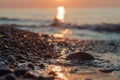 Close-up view of a pebble beach with blurred sea and sun background Royalty Free Stock Photo