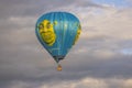 Close-up view of people flying in Shrek hot air balloon in cloudy blue sky. Royalty Free Stock Photo