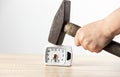 Close up view of person hand holding hammer and smashing alarm clock. Royalty Free Stock Photo