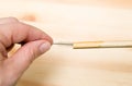 Close up view of person using drinking straw cleaner brush to clean reusable bamboo drinking straw.