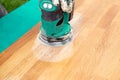 Close up view of person working with sander tool, sanding off stains on old damaged butcher block. Royalty Free Stock Photo